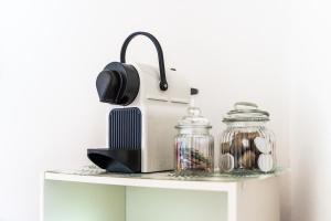 a table with a toaster and glass jars on it at Residence L'Olivastro in Castelsardo