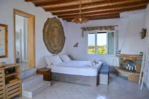 a bedroom with a large bed and a window at XALAKAS SUMMER HOUSE in Empourios