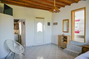 Sala de estar con silla y dormitorio en XALAKAS SUMMER HOUSE en Empourios