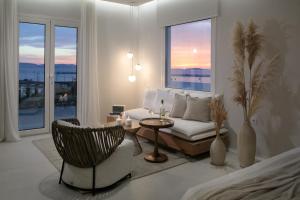 a living room with a bed and a table and chairs at Porta Marina in Naxos Chora