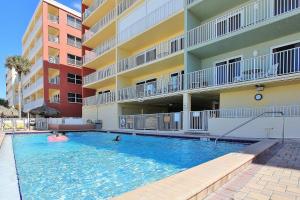 a swimming pool in front of a apartment building at Ram Sea I 206 in St Pete Beach