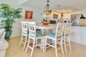 a kitchen with a table and four chairs at Ram Sea I 206 in St Pete Beach