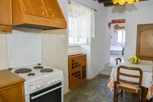 a kitchen with a stove and a counter top at XALAKAS SUMMER HOUSE in Empourios
