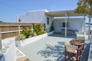 a patio with a table and chairs and a fence at XALAKAS SUMMER HOUSE in Empourios