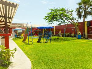 a park with a playground with a slide at Hotel Los Arcos de Imperial in San Vicente de Cañete