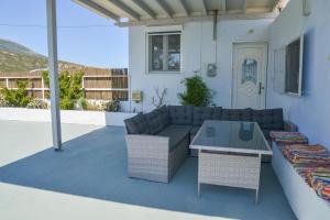 a patio with a couch and a table at XALAKAS SUMMER HOUSE in Empourios