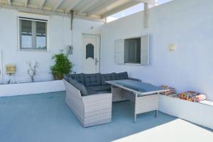 a patio with a table and wicker chairs at XALAKAS SUMMER HOUSE in Empourios