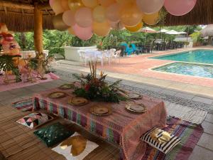 a table is set up next to a swimming pool at Hotel y Restaurante Mesón del Gitano in Caucasia