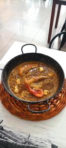 a pan of food in a basket on a table at Hostal Vila del Mar in Lloret de Mar