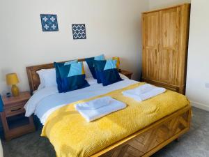 a bedroom with a bed with two towels on it at Modern Family Home with Off-Road Parking in Cardiff