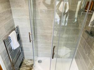 a shower with a glass door in a bathroom at Modern Family Home with Off-Road Parking in Cardiff +20 photos