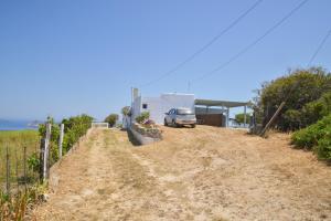 a dirt road with a car parked next to a building at XALAKAS SUMMER HOUSE in Empourios