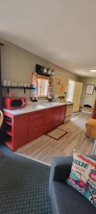a large kitchen with red cabinets in a living room at Swiftcurrent Lodge in Estes Park