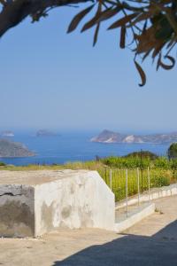 a stone wall with a view of the water at XALAKAS SUMMER HOUSE in Empourios