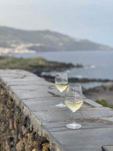 two glasses of white wine sitting on top of a wall at Apartamentos Cancajos in Los Cancajos