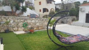 a chair in a yard with a rock wall at γαληνη in Vamos +9 photos