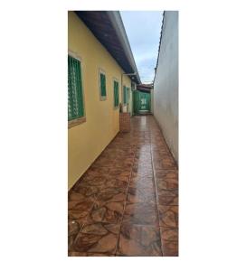 a corridor of a building with a stone floor at Lar Doce mar in Mongaguá