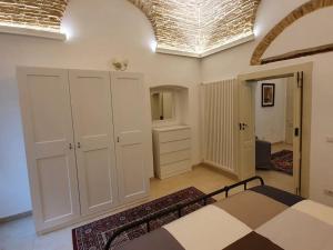 A bed or beds in a room at Casa Santa Maria - Beautifully restored house in centro storico Irsina Basilicata Puglia