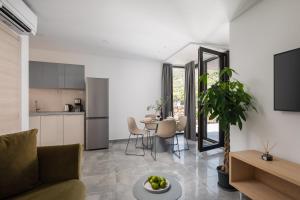 a kitchen and living room with a couch and a table at Residence THE ONE - new in Komiža