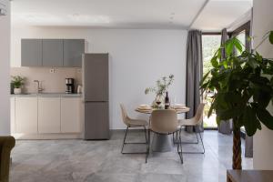 a kitchen and dining room with a table and chairs at Residence THE ONE - new in Komiža