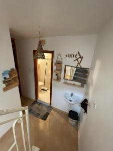 a bathroom with a sink and a mirror at We surf Morocco BOUTIQUE HOUSE in Taghazout +113 photos