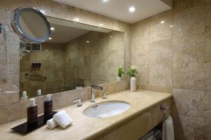 a bathroom with a sink and a mirror at Melia Cozumel All Inclusive in Cozumel