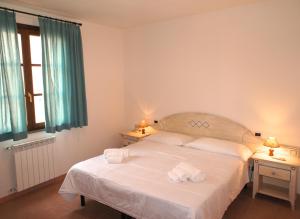 a bedroom with a bed with two towels on it at Appartamenti in Residence Villa Santa Maria in San Vincenzo +49 photos