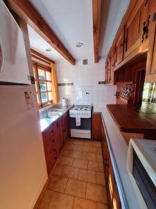 a kitchen with a sink and a stove at Hotel Angostura in Villa La Angostura