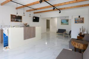 a living room with a counter and a table at Luxury Sirens Fresh in Limenas