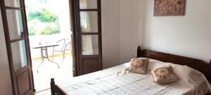 a bedroom with a bed with two pillows on it at Votsalo Beach House in Moutsoúna