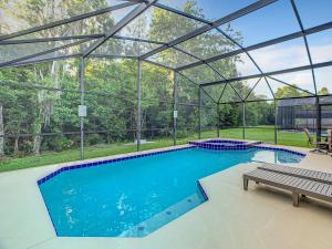 an indoor swimming pool with a glass roof at Casita mi Encanto a Cozy & Spacious House, 4-bedroom 3-Bath & pool in Kissimmee