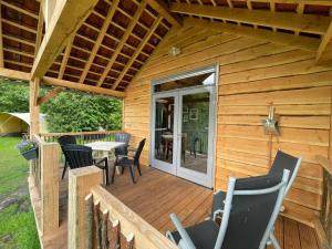une cabine avec une terrasse dotée d'une table et de chaises dans l'établissement Trekkershut - 4 personen, à Beilen