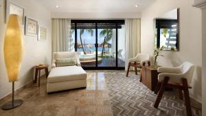 a living room filled with furniture and a large window at Melia Cozumel All Inclusive in Cozumel