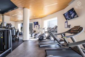 a gym with treadmills and ellipticals in a room at Harbor Puerto Vallarta 1006 in Puerto Vallarta