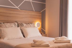 a bedroom with a large bed with white pillows at Asya Sea View Apartment in Plános