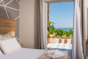 a bedroom with a bed and a view of the ocean at Asya Sea View Apartment in Plános