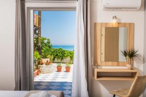 a bathroom with a sink and a mirror at Asya Sea View Apartment in Planos