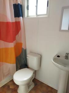 a bathroom with a toilet and a sink at Container home in Santa Teresa de Lo Ovalle