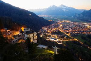 a city with a statue of a christ the redeemer on a mountain at Komplettes Hotel mit 10 Zimmern in Bad Ragaz