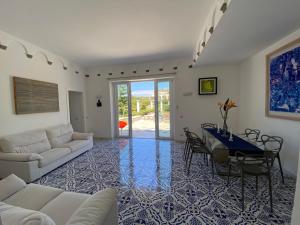 a living room with a couch and a table at Villa Raffaella in Capri