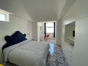 a bedroom with a bed and a tv in it at Villa Raffaella in Capri +33 photos