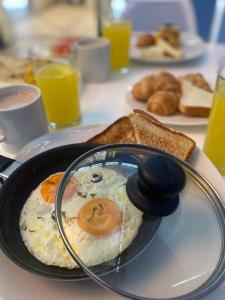 a plate of food with eggs and toast on a table at HOTEL BRANA in Medellín