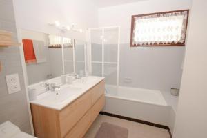 a white bathroom with a sink and a bath tub at Coquet appartement Type 2 de 56 m² en centre ville in Briançon