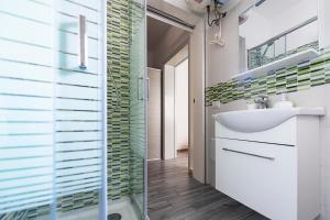 a bathroom with a sink and a mirror at B&B La Terrazza Sul Porto in San Foca +18 photos