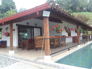 a house with a swimming pool and a patio at Finca la Isabella in Fredonia