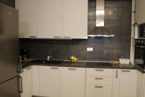 a kitchen with white cabinets and a sink at Apartment D&E Punat - free Wi-Fi and parking in Punat +42 photos