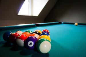 a group of billiard balls on a pool table at Maison Remy in Ypres