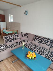 a living room with a couch with a blue table at Apartment Pantovic in Plužine