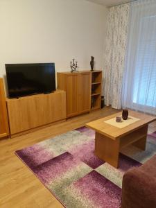 a living room with a television and a coffee table at Apartment NH12 in Bratislava