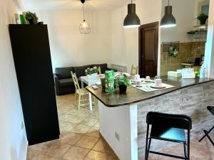 a kitchen and living room with a counter and a table at Lisetta's house in Monreale